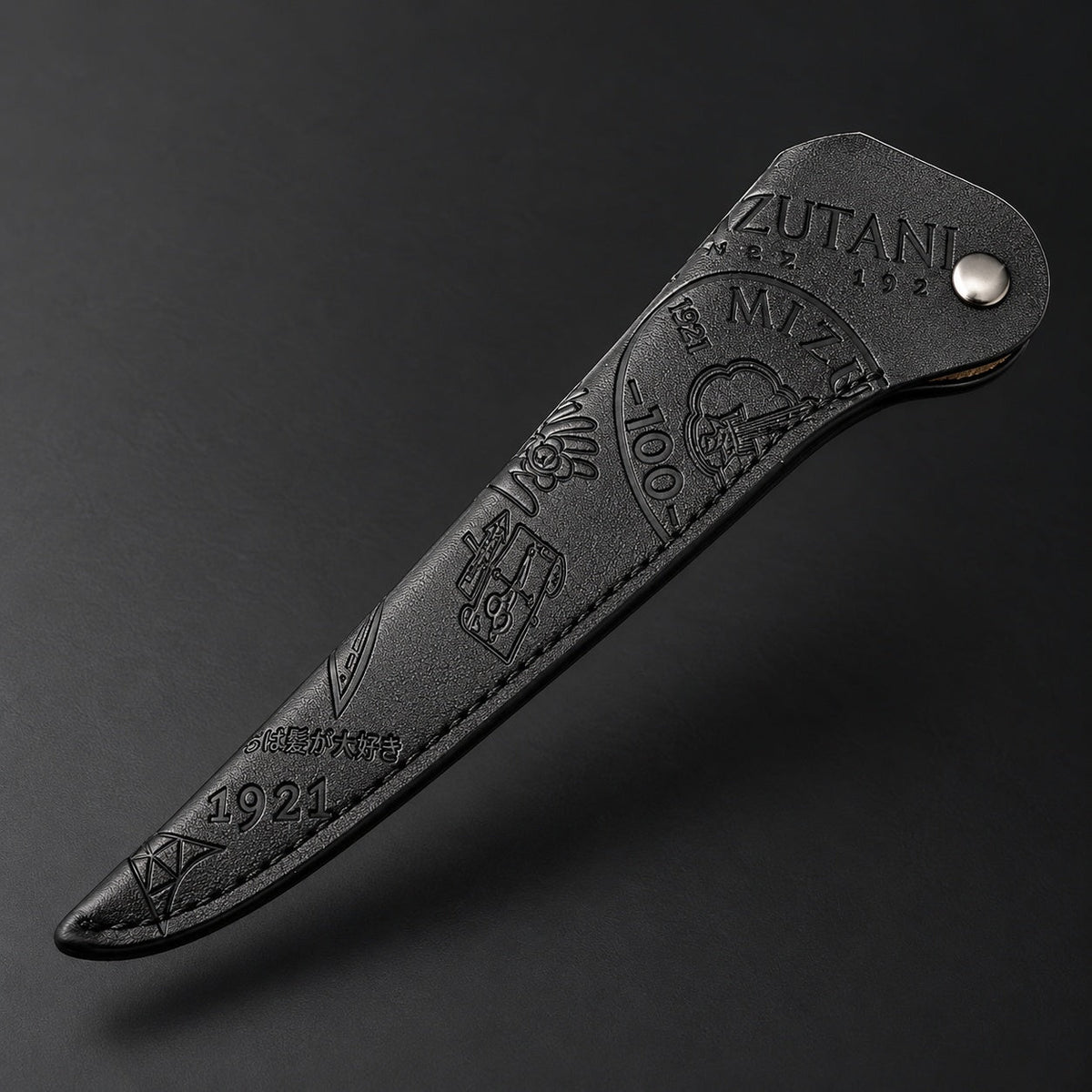 Mizutani Heritage Edition black embossed scissor sleeve, floating view showing tonal pattern and snap closure
